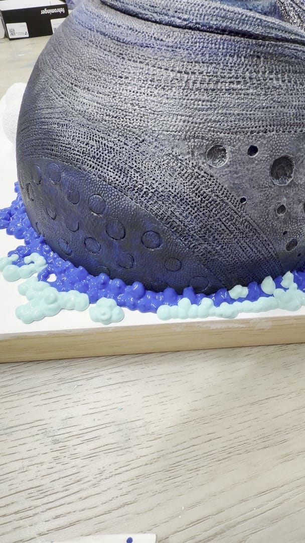 Studio process clip: close view of the dark dimpled encaustic dome of Eye Sea All I, blue and turquoise piped reef ridges around its base