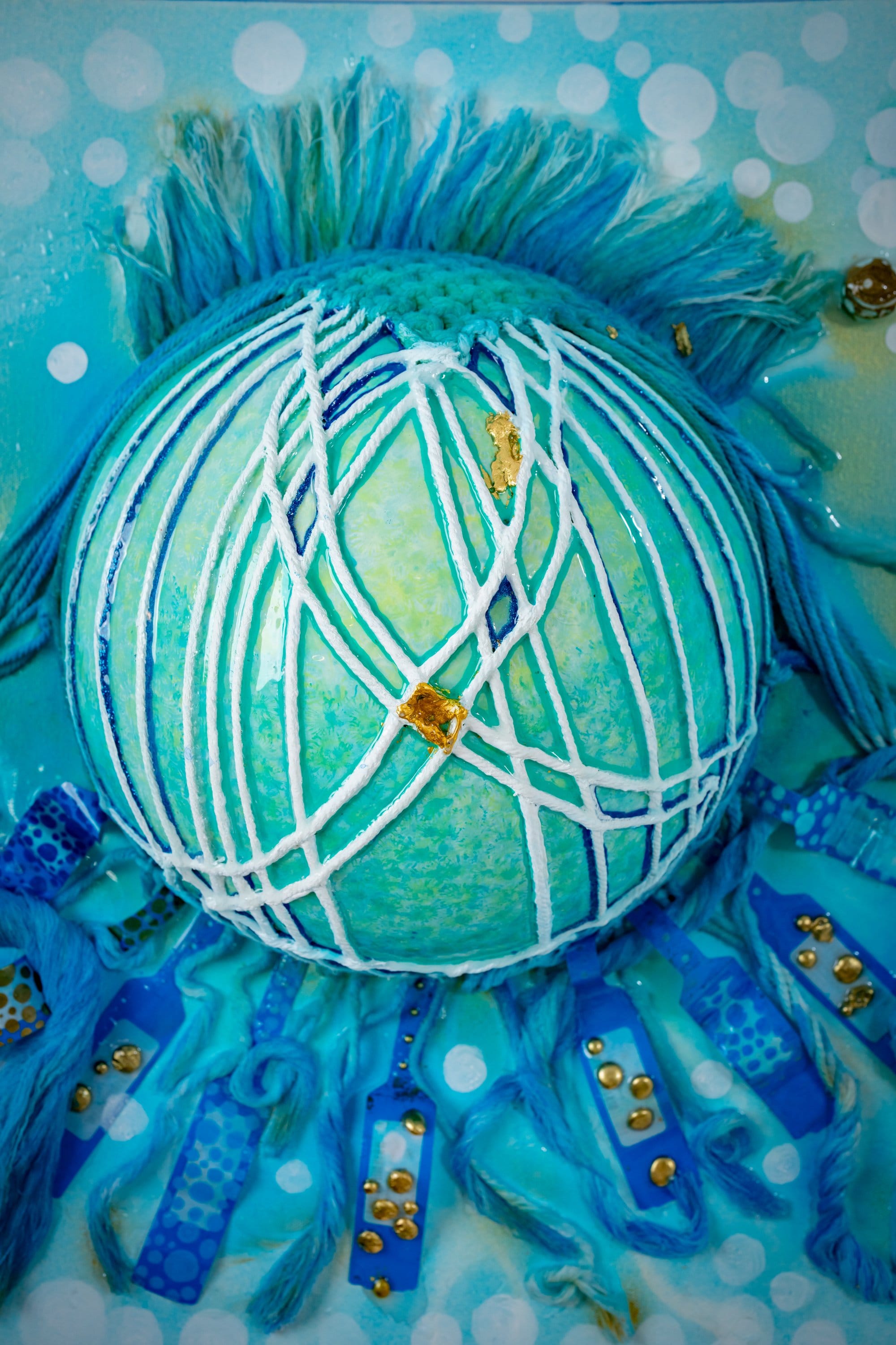 Surface texture detail of Faceless Self Portrait, encaustic sphere and mesh on cerulean