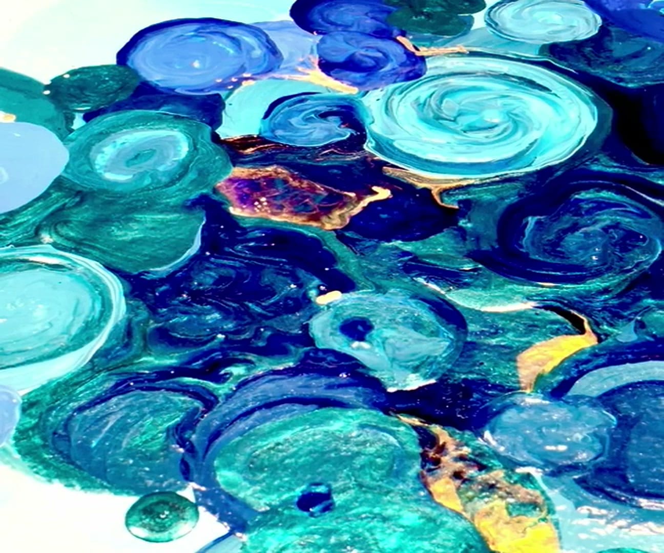 Macro of wet paint in cobalt and turquoise with gold-leaf accents and dimensional brush layers
