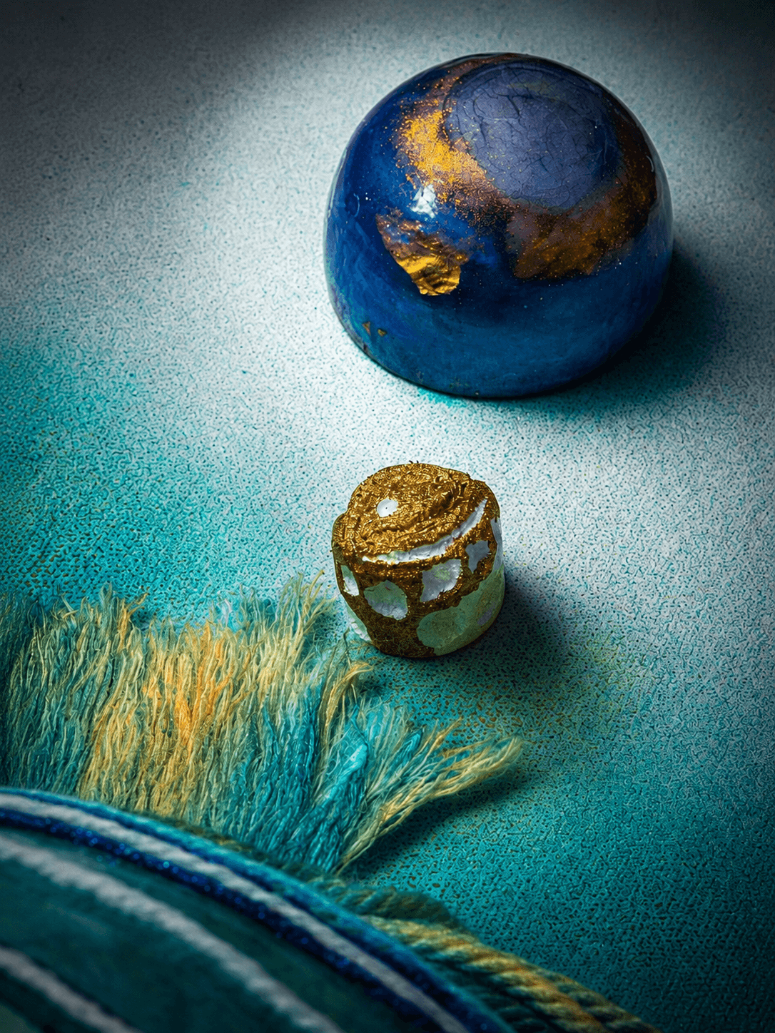 Jellyfish — Detail by Victoria Zeder — close-range view of dark cobalt sphere with gold-leaf accents and thread fringe