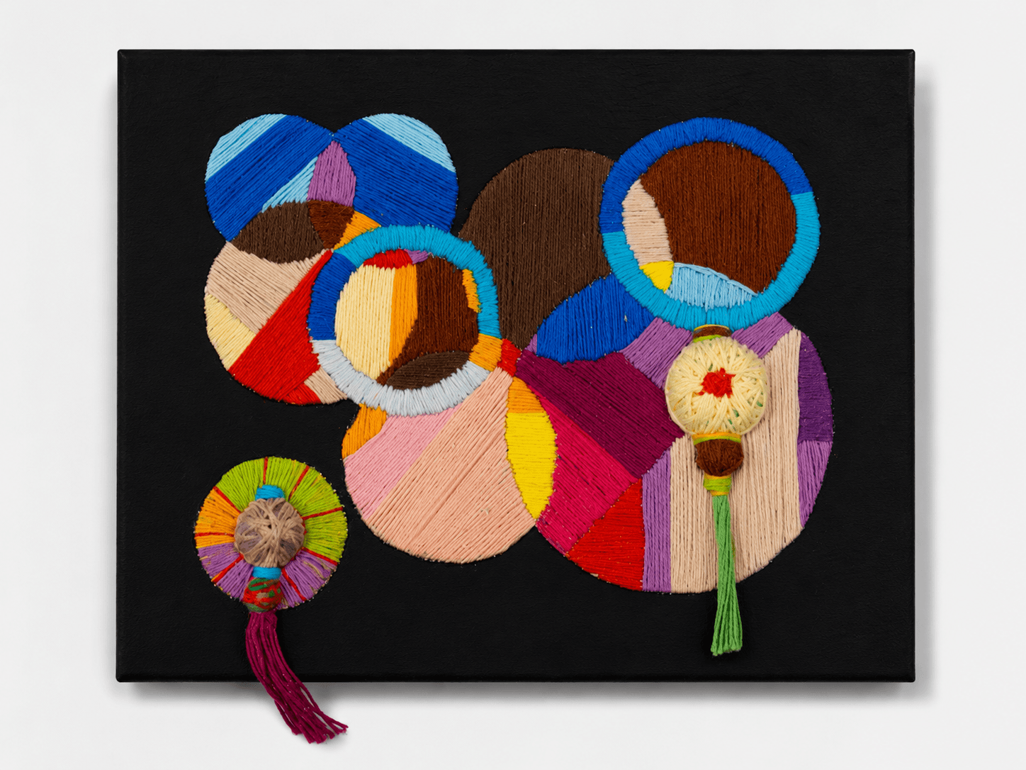 Thread on Black II by Victoria Zeder — smaller thread work on black canvas with overlapping circles and two hanging tassels