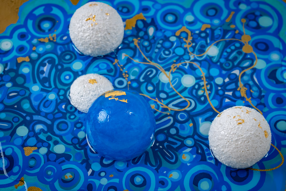 Genesis: surface texture detail showing hand-carved spheres and gold filament