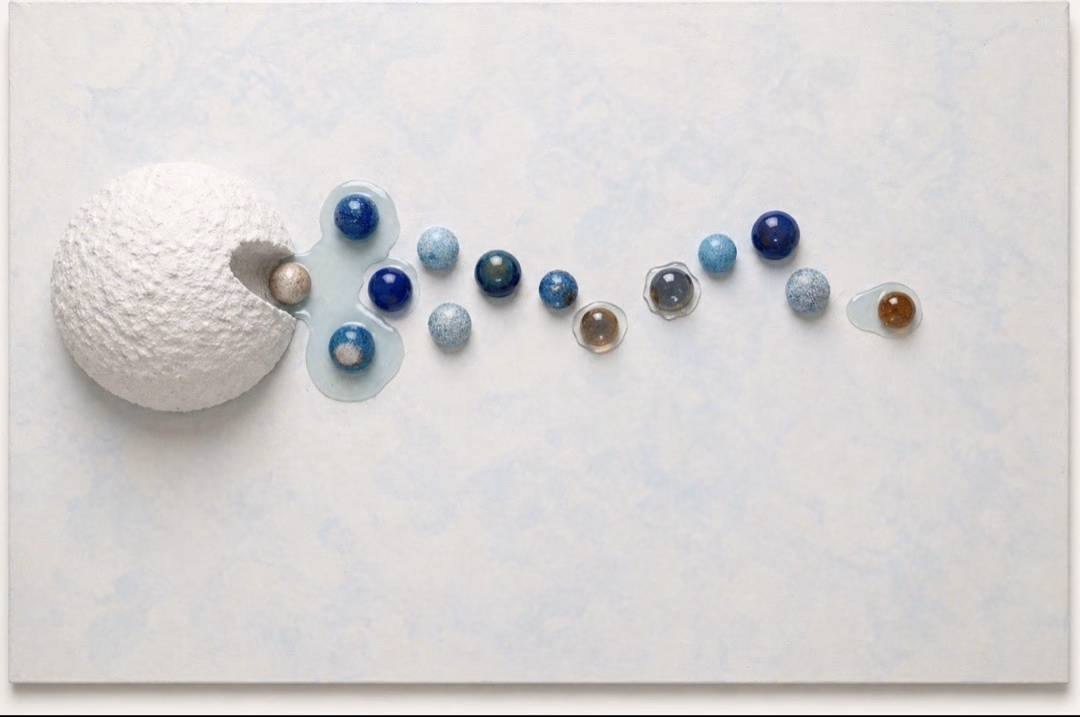 Origin / Release I by Victoria Zeder: small resin spheres moving across a pale cerulean field like traces or memories