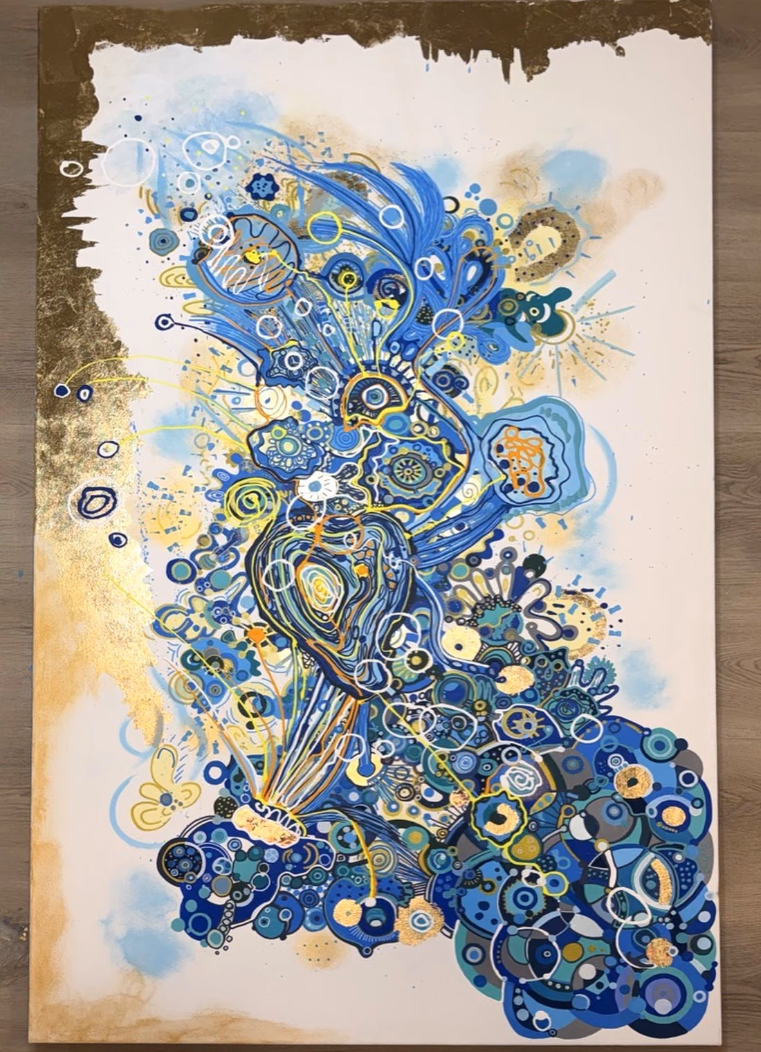 Pareidolia in Blue by Victoria Zeder: large blue painting with gold leaf, thread, and encaustic, faces emerging from the field