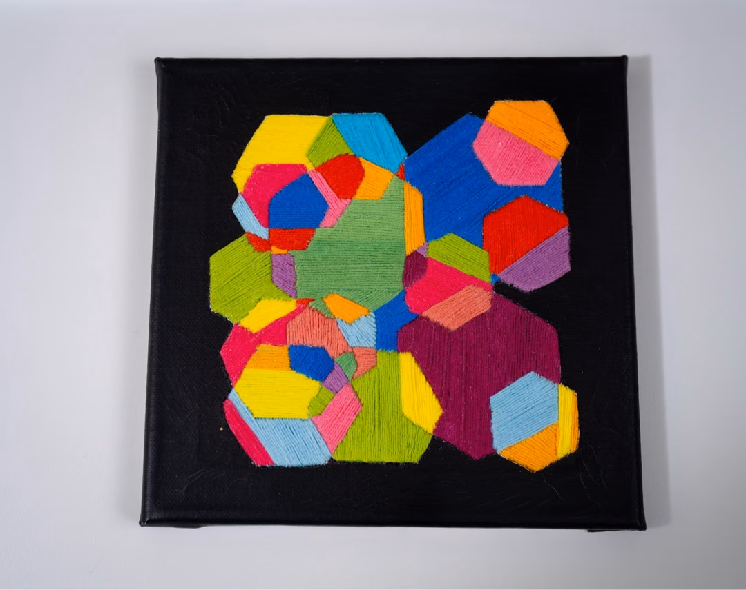 Thread on Black II by Victoria Zeder: smaller thread work on black canvas with overlapping circles and two hanging tassels